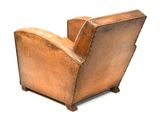 an image of a brown leather chair sitting on top of a white floor