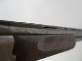 an image of a close up of a rifle on a table