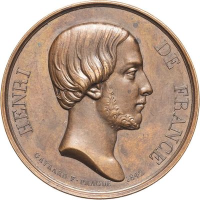 an image of a bronze medal with a man ' s face on it