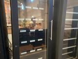 two glass doors that are next to each other in a room