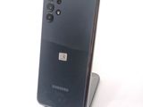a close up of a cell phone on a stand on a white surface