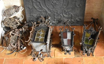 many different pieces of art on the floor next to a fire place