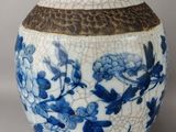 a blue and white vase with a bird on it