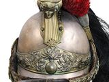 a close up of a helmet with a red feather on it