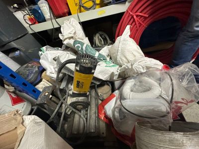 a pile of assorted items in a cluttered room
