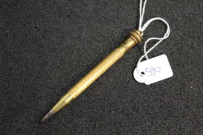 a pen with a tag attached to it sitting on a table
