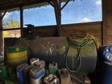 a large tank of gas sitting next to other containers