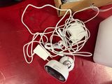 a red table with a laptop and a bunch of cords