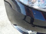 a close up of a car ' s headlight on a street