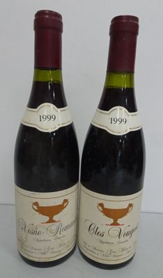 two bottles of wine sitting on top of a table next to each other