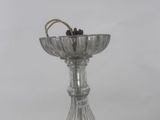 a silver plated candle holder with two candles on it