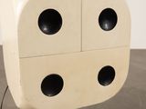 a large white dice with four black holes on it