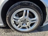 a silver car with a flat tire on the street