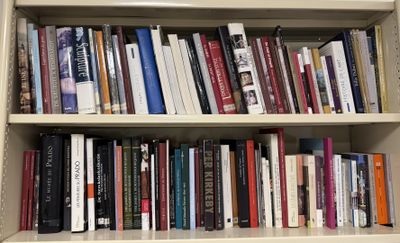 a book shelf with many books on it in a room