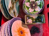a red basket filled with assorted plates and bowls