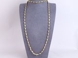 a gold chain necklace on a mannequin mannequin display