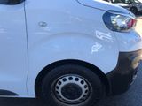 a small white van parked in a parking lot