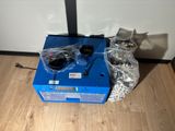 a blue box sitting on the floor next to a pair of glasses