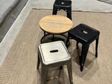 three stools and a table in a room