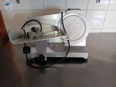 an image of a meat slicer on a counter top