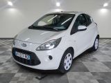 a picture of a small white car parked in a garage