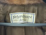 brown coat with a fur collar and a name tag on it
