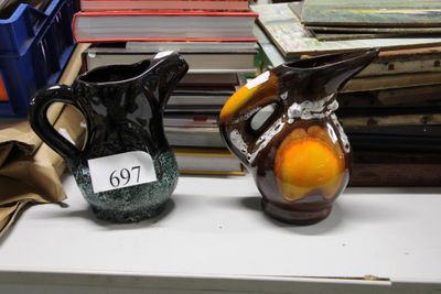 two vases that are sitting on a shelf