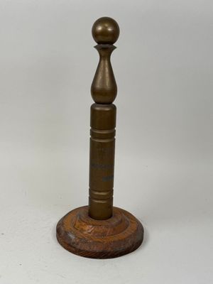 pair of antique brass candlesticks on a wooden base