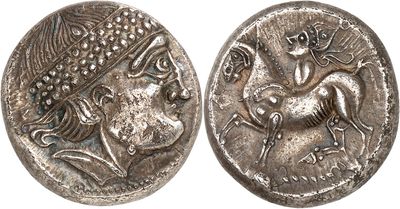 a silver coin with an image of a man riding a horse