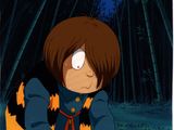 an image of a cartoon of a boy with brown hair and an orange and black jacket