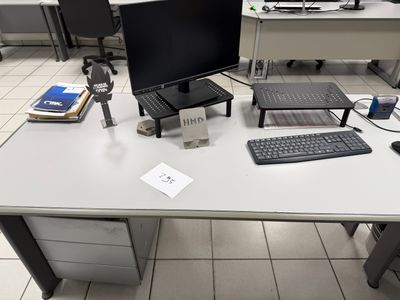 a desk with a computer, keyboard, mouse and monitor on it