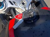 a close up of a motorcycle with a red handle on it