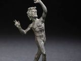 une image représentant une statue en bronze d'un homme tenant une raquette de tennis