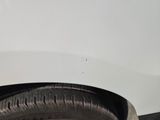 a tire on the side of a white car