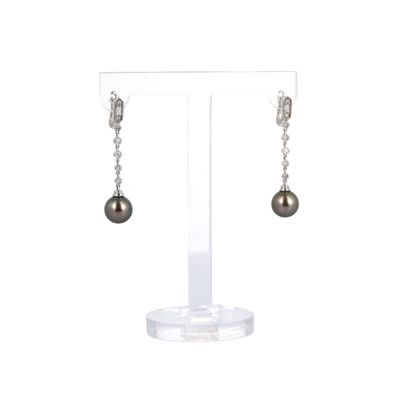 une paire de boucles d'oreilles ornées de perles suspendues à un support