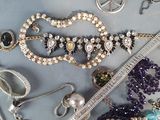 many different types of jewelry displayed on a table