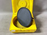 an open yellow box with a black lid and a gray lid