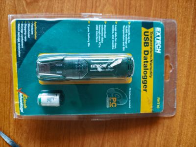 un emballage en plastique contenant un stylo et une paire de ciseaux, posé sur une table
