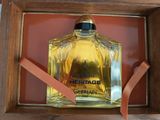a bottle of perfume sitting in a wooden box