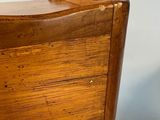 an image of a wooden chair with a brown seat and back