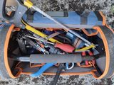 a bag full of tools sitting on the ground