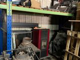 a pile of junk in a garage next to a fire place
