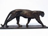 statue of a cheetah on a marble base on a white background