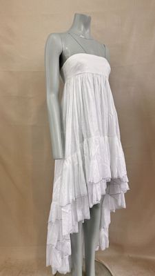 a mannequin with a white dress on a mannequin base