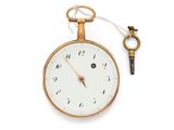 a gold pocket watch with a key attached to it