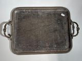 silver tray with handles and handles on a white surface