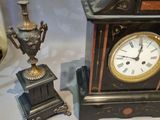 a clock that is sitting on a table next to other items