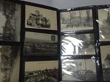 a lot of old black and white photographs on a table