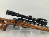 a rifle with a scope and a scope scope on a stand
