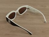 a pair of sunglasses that are on a wooden table